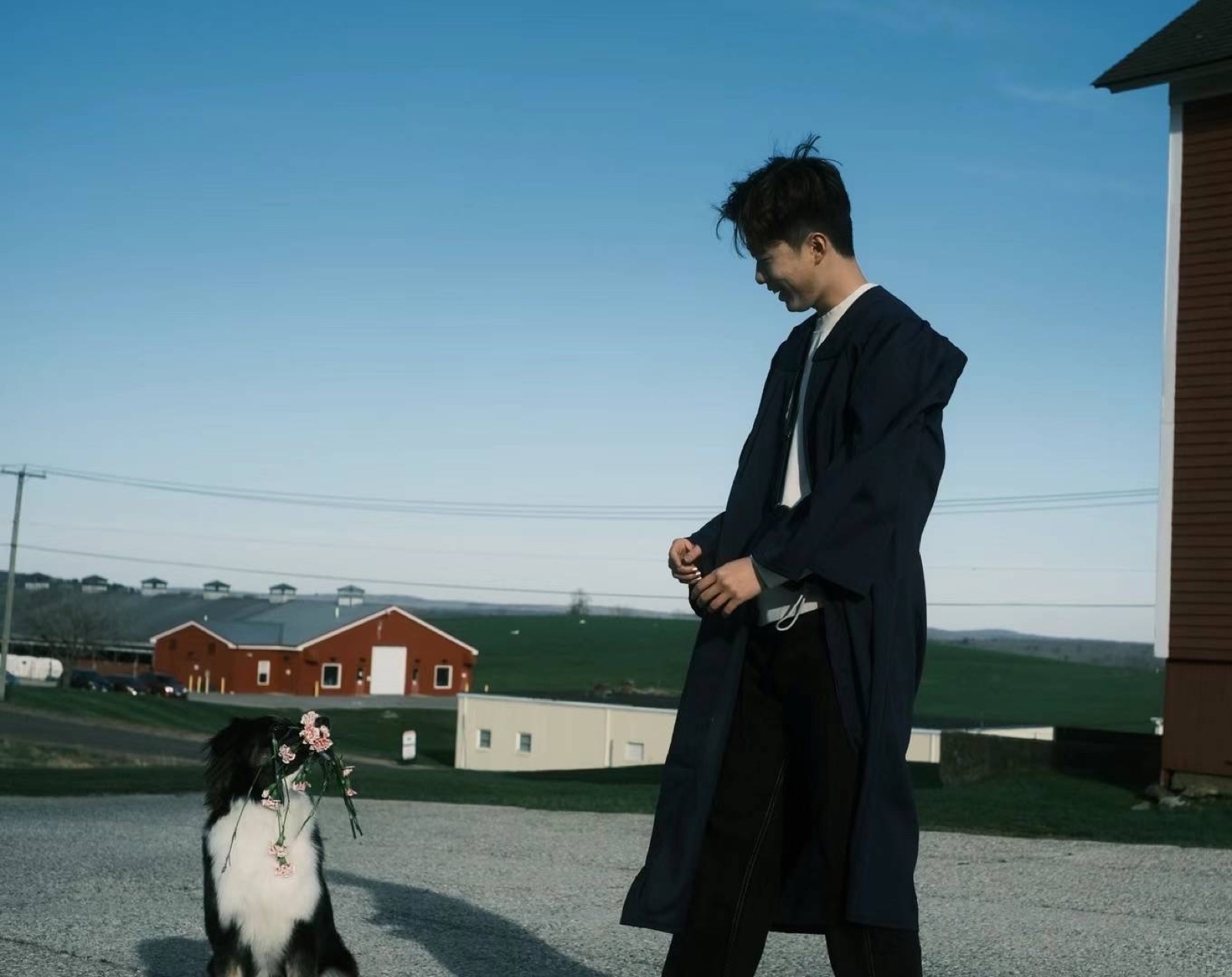 Xingye Zhang standing outdoors beside Molly